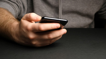 Close up of a man using mobile smart phone. Smartphone in male hands