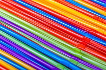 Colorful plastic drinking straws, close up background, summer cocktail accessories