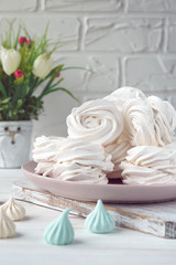 Fototapeta na wymiar Handmade apple white homemade marshmallows on a pink plate. White background.