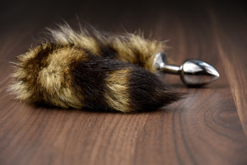 Anal tail stock images. Erotic toy on a wooden background. Erotic toy stock images. Adult sex toy....