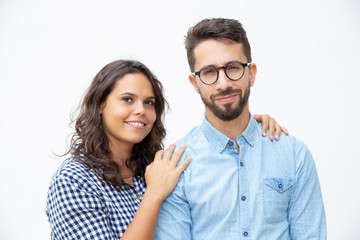 Cheerful young couple smiling at camera. Front view of beautiful young man and woman in casual clothing standing together and smiling at camera. Relationship concept