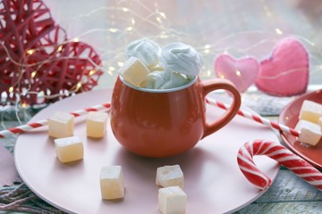 Cup of coffee with meringues and marshmallows, Turkish delight on a plate, hearts, illumination, against the background of a window, homeliness, Valentine's day
