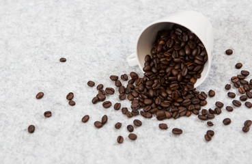 Roasted coffee beans in a caffe mug