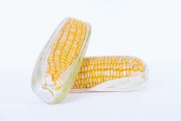 Close-up of a corn cob resting on another