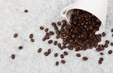 Roasted coffee beans in a caffe mug