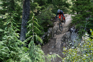 riding down a steep rock with mountainbike in whistler, canada