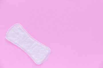 Daily women's gasket on pink background. Top view
