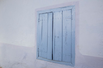 closed blue colored wooden window blinds of a house