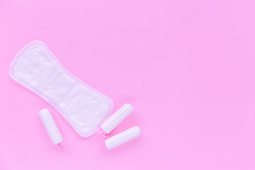 Daily pad and swab on a pink background