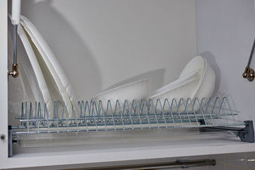 white dishes in the kitchen cabinet