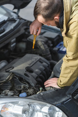 Guy is repairing car on the road