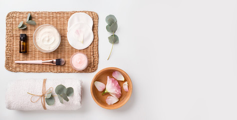 Spa composition of natural materials and rose petals on white