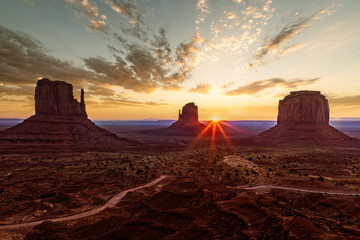 First sun rays at sunrise are hitting the monuments at Monument Valley