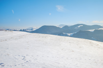 Fototapeta na wymiar sun over the winter mountains with snow, Cindrel mountains, Paltinis, Romania
