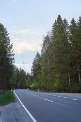 Large wind farm in the coniferous forest of the Schwarzwald Forest and the road. Ecology and green technology concept