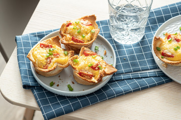 Baked egg, ham, tomato and toast cup for breakfast brunch.