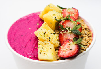 pink smoothie bowl with fruit, oats and chia seeds