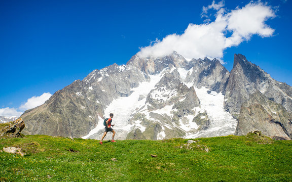 A trail runner running in the high mountains of the Alps