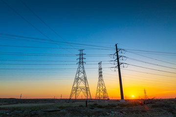 High voltage electric tower on sunrise time and sky on sunrise time background.Jubail Highway-Saudi Arabia.