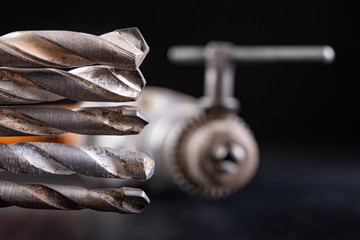 Drill and drills on a workbench. Tools for construction workers.
