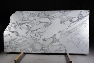 A large slab of natural white stone with gray veins is called marble Arabescato Corchia