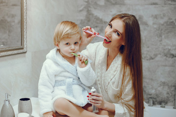 Family in a bathroom. Beautiful mother with little son