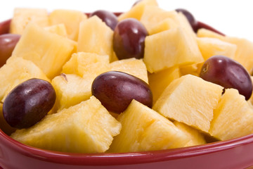 fresh pineapple and grapes in serving bowl
