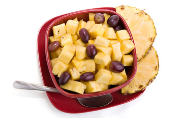 fresh pineapple and grapes in serving bowl