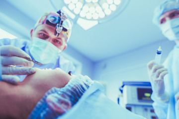 Man surgeon at work in operating room