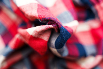 Plaid material texture. Red, blue and white cage clothes background
