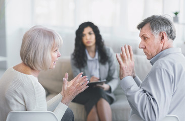 Elderly couple having fight in therapy during session