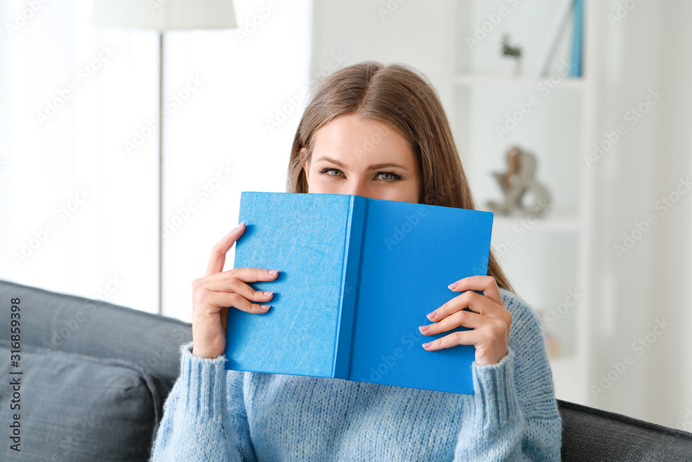 Sticker Beautiful young woman reading book at home