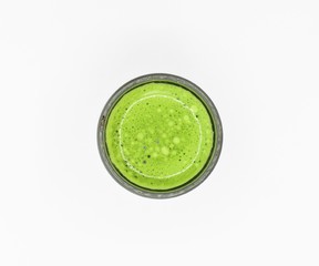 green elixir shot glass on white background