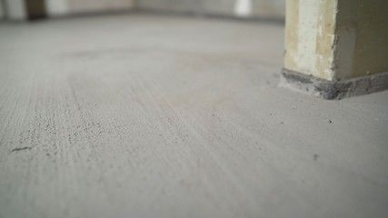 Construction worker Concrete pouring during commercial concreting floors of building in...