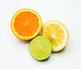 cut piece of an orange, lemon and lime on a white background