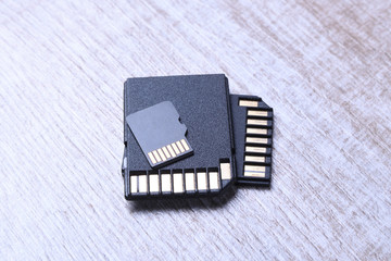 Micro SD memory card adapter on the wooden backgroundtable. close up