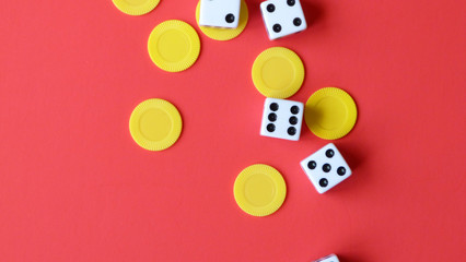 Flat Lay of Dice and Yellow Chips on a Red Background | Game Night