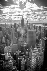 Fototapeta na wymiar New York, United States »; January 5, 2020: Top of the Rock in New York, the Empire State Building surrounded by skyscrapers. Black and white photo