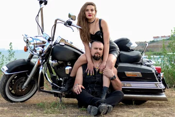 Foto op Plexiglas biker couple in leather clothes against the cool expensive bike. hot woman in leather dress with motorcycle © Viktoria