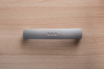 The metal handle of the drawer. Furniture element.