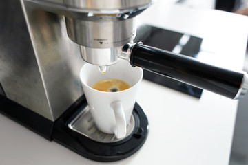 Close-up of making coffee in a coffee machine.