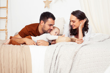 young happy family together having fun in bed, lifestyle people concept at home