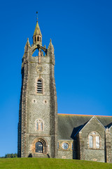 Vertical photo of Tarbert Parish Church tower. Hebrides, Scotland.