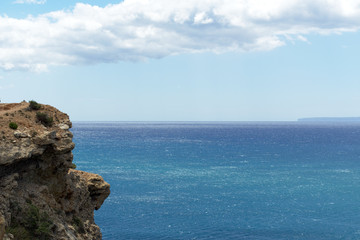 Rocky sea coast with clean bule water and vegetation. Ibiza island, Spain