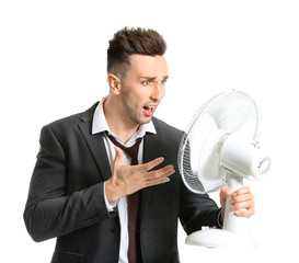 Indignant man with electric fan on white background