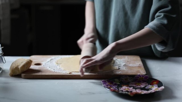 Woman making cookies with Primula petals