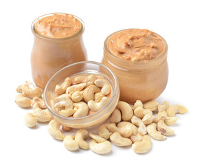 Jars of cashew butter on white background