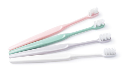 Different tooth brushes on white background