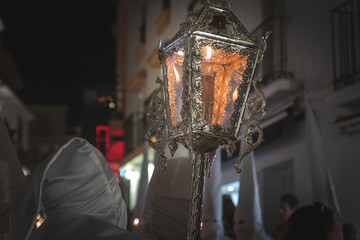 Nazarene in a procession at the holy week holding a candle