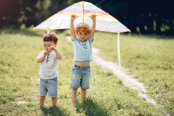Little child in a summer field. Kids playing with a Kite